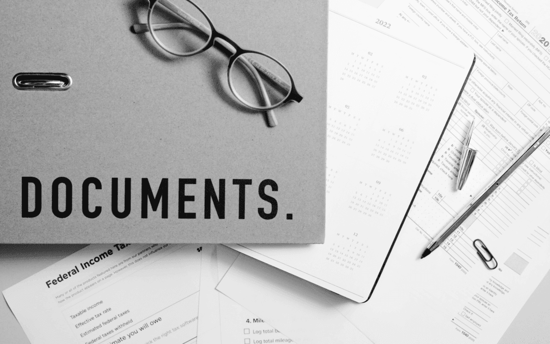 property documents with eyeglasses on wooden table 1080x675