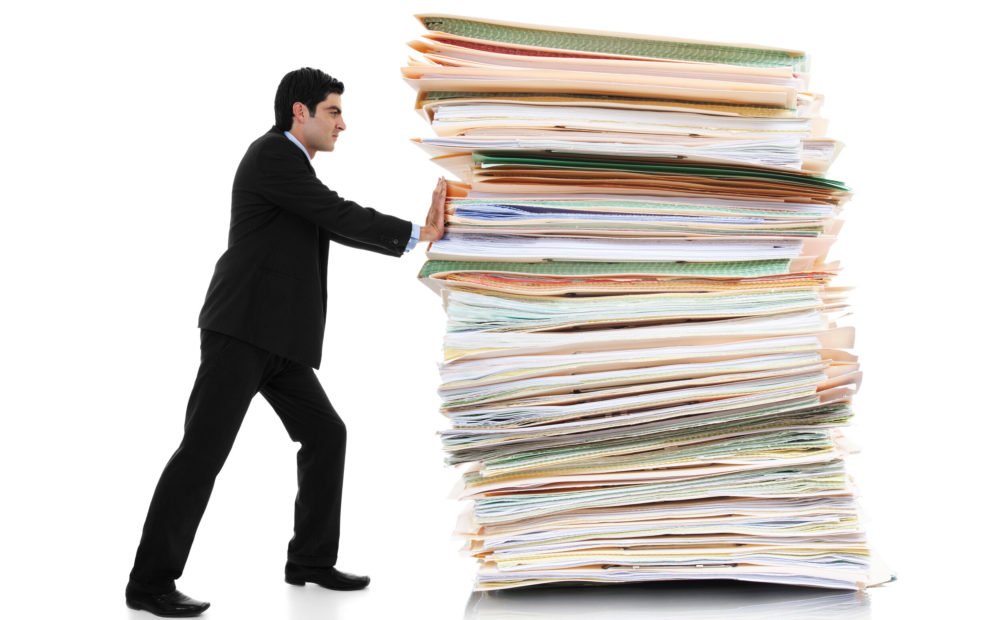 man pushing paper away to form a paperless property management office